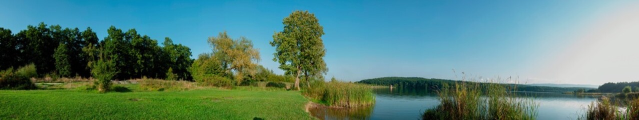 Panorama lake view in sunrise time.Sunrise at the lake