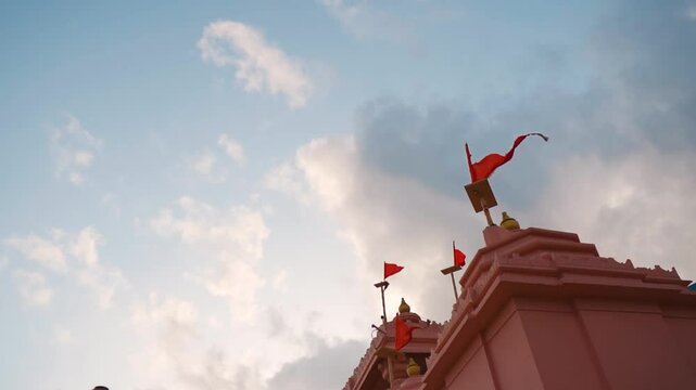 Architecture of Hindu temple and flag fluttering in wind at Kashi Vishwanath temple at Mandvi, Gujarat, India. Shiva temple in India. Faith, hope and spirituality concept. Indian culture