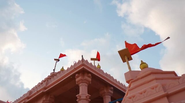 Architecture of Hindu temple and flag fluttering in wind at Kashi Vishwanath temple at Mandvi, Gujarat, India. Shiva temple in India. Faith, hope and spirituality concept. Indian culture