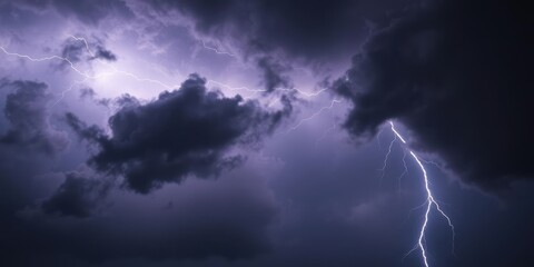 Obraz premium Stormy night sky with bright lightning and dark clouds, ominous clouds, turbulent weather