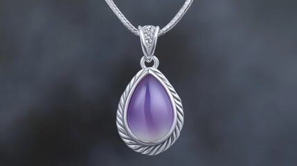 Intricately designed gemstone pendant with engraved details, elegantly resting against a subtle color gradient