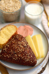 Assortment of various breakfast foods and drinks on the white table. Selective focus.