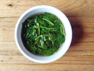 Spinach soup in bowl on wooden table background, Vegetarian cuisine 