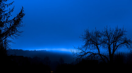 Fototapeta premium Dark blue sky with clouds, a background of the night sky, a view of the sky, dark and light, a foggy, fantasy landscape, with a cinematic feel. 