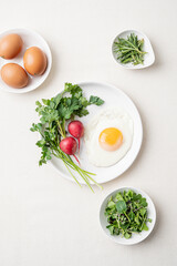 Fried egg with radish and vegetables for breakfast