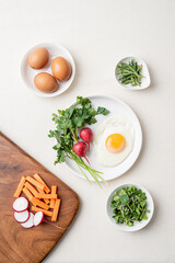Fried egg with radish and vegetables for breakfast