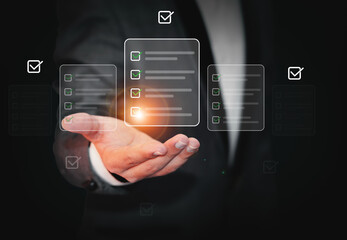Checklist with green mark tick and floating files over the hand, background. Man in gray suit showing check list items, backdrop design