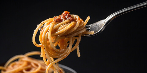 Close-Up of Spaghetti Twirled on a Fork Against a Dark Background for Culinary Photography