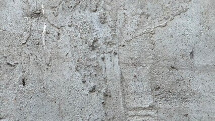 Concrete wall with rough texture and subtle markings in urban setting