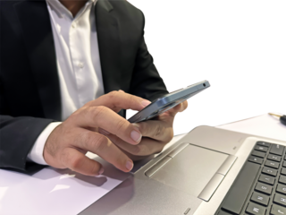 Person using mobile phone sitting in front of the laptop with white table, no face, businessman, transparent backdrop png