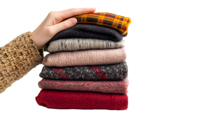 A hand holding a stack of clothes, isolated on a white background