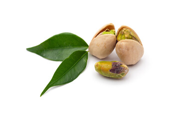 pistachio nuts with green leaves on white background