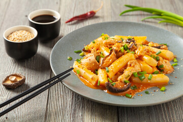 Traditional Korean Tteokbokki rice noodles with chicken, vegetables and shitake mushrooms. Prepared in a pan.