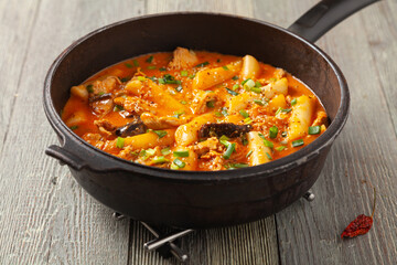 Traditional Korean Tteokbokki rice noodles with chicken, vegetables and shitake mushrooms. Prepared in a pan.