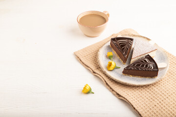 Chocolate and Vanilla Cake pops Marshmallow with cup of coffee on white wooden, side view, copy space.