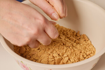 woman's hands working with cake dough