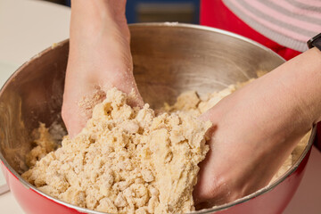 woman's hands working with cake dough