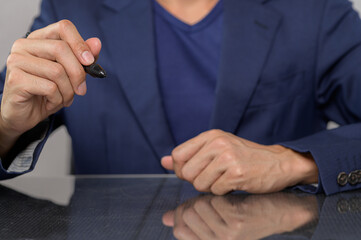 Business Professional with Pen Ready to Take Notes in Meeting