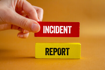 Incident report message written on wooden blocks on brown background. Conceptual incident report...