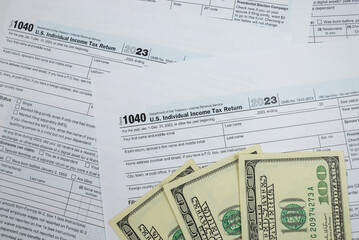 Obraz premium us tax forms 1040. For 2023, business tax time concept.