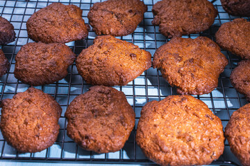Freshly baked homemade biscuits on a black lattice on a white background.