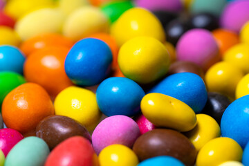 Colorful candy in shapes. Brightly colored candy eggs fill the frame, showcasing a variety of hues and sizes, perfect for any sweet tooth.
