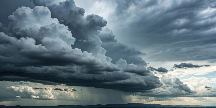 A dramatic, dark, and ominous sky filled with heavy rain clouds, showcasing the power of nature