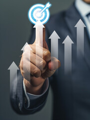 Strategic Touch, A businessman's finger precisely touches a target icon, symbolizing strategic planning and achieving business goals, with upward trending arrows rising around it.