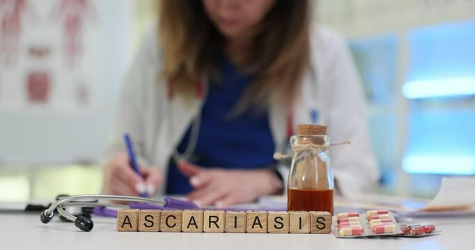 A healthcare professional is engaged in studying ascariasis with various medications spread across the table