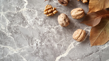 Dried walnuts with leaves arranged on stone surface, showcasing natural textures and colors. composition evokes sense of warmth and earthiness