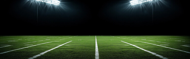 Football field illuminated by stadium lights, with dark background and ample copy space for advertising or text.
