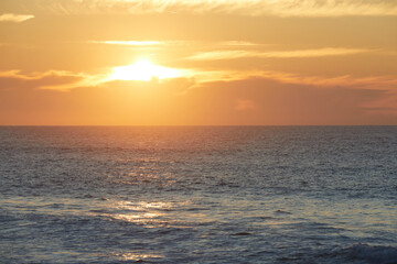 Sunset over beach in Portugal, Horizon Sea Sky Background, Sunset sky clouds over sea in the evening with Orange, Yellow sunlight Golden hour in Summer landscape, Dusk sky