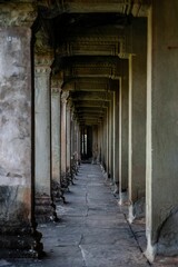 Fototapeta premium Historic stone corridor at Angkor Wat, Cambodia.