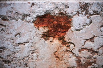 Weathered wall texture with exposed brick and crumbling plaster, showing age and decay.