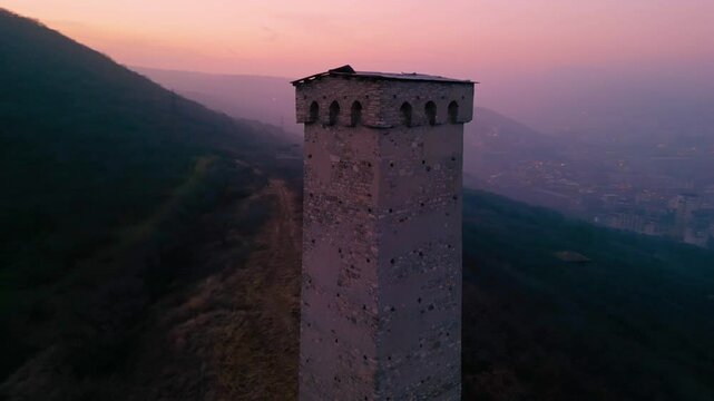 ancient watchtower near modern metropolis - drone view at dawn, georgia, tbilisi