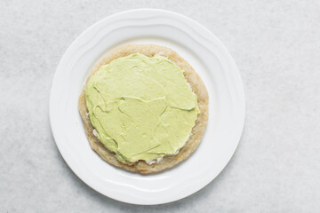 Overhead view of frosted lime and vanilla cookies, top view of bakery style lime cookies 