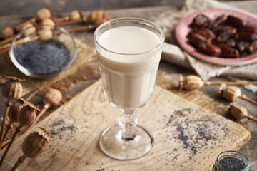 Vegan poppy seed milk in a glass cup