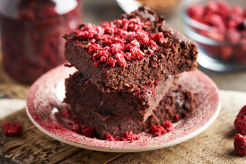 Homemade gluten-free brownies made with red kidney beans, oat flakes, chocolate and freeze-dried raspberries
