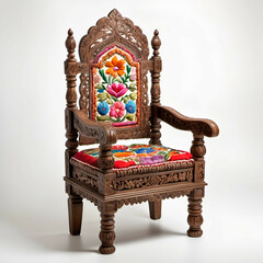 Fototapeta premium Indian Hand-Carved Chair: A richly detailed, hand-carved wooden chair with colorful embroidered cushions, presented against a white background.