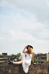 Fototapeta premium Travel, fashion and woman in portrait outdoor for summer holiday, sightseeing or city scenery on rooftop. Mockup space, person or trendy style in urban town for vacation break or relax with Rome view