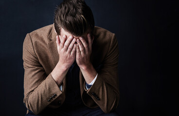 Business man, sad and crying in studio with bankrupt, stress or recession with mistake by...