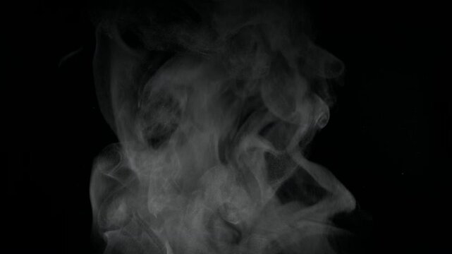 
White natural rising steam from food or hot drink isolated on a black background. Сan be used in any projects with hot food.
