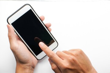 Mockup of male hand holding cell phone with blank screen