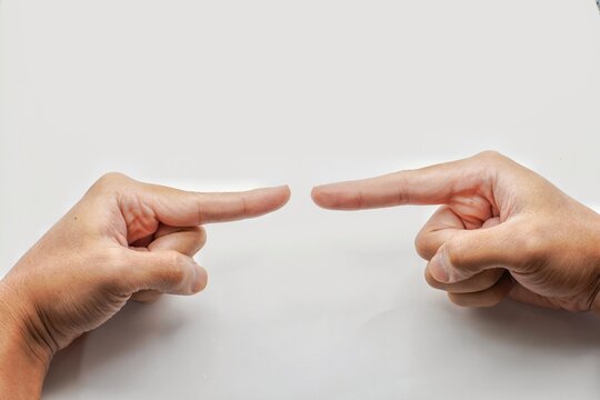 Opposed hands of asia man pointing at each other wit index finger isolated on gray background