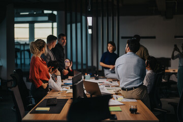 A group of multicultural and multigenerational employees engage in a brainstorming session,...