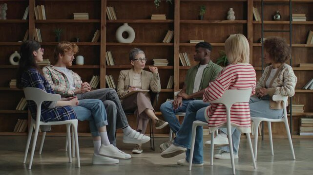 A diverse group of six adults participates in a meaningful therapy session, fostering connection and understanding in a supportive environment