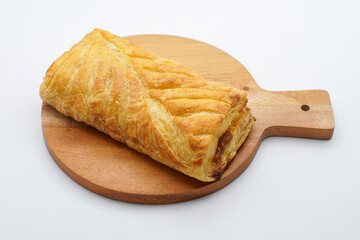 sweet bread on a wooden cutting board. freshly baked sweet bun isolated on white background.