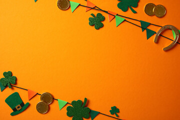 St. Patrick's Day decorations with green shamrocks, a leprechaun hat, gold coins, and colorful...