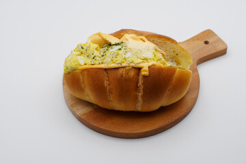 cheese egg sandwiches on a wooden cutting board