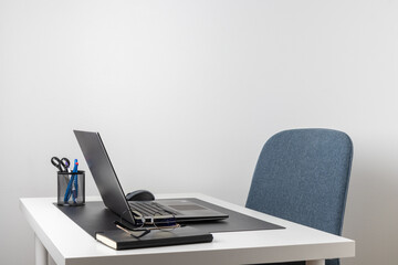 Laptop computer, notebook, and eyeglasses and headphones on a desk, place for work and study, home freelancer's office